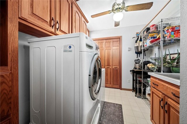 clothes washing area featuring ceiling fan, cabinets, and washer / dryer