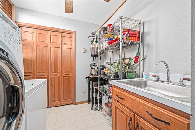 washroom featuring cabinets, washer / dryer, and sink