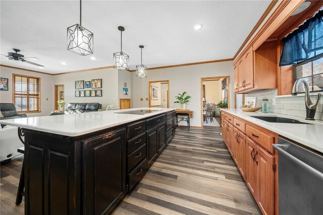 kitchen with a center island, decorative light fixtures, sink, stainless steel dishwasher, and black electric cooktop