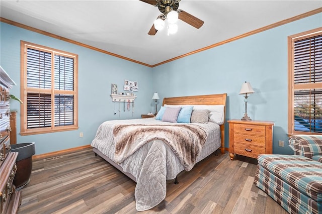 bedroom featuring dark wood-type flooring, ceiling fan, crown molding, and multiple windows