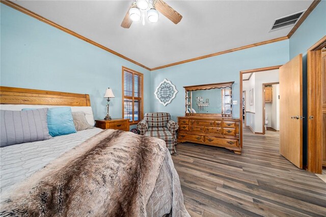 bedroom with ceiling fan, dark hardwood / wood-style floors, and ornamental molding