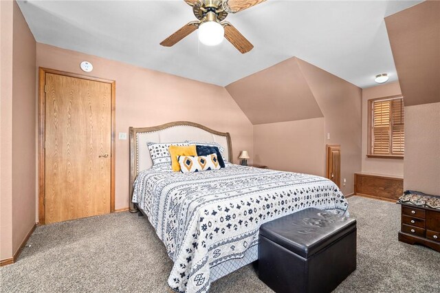 carpeted bedroom with ceiling fan and lofted ceiling