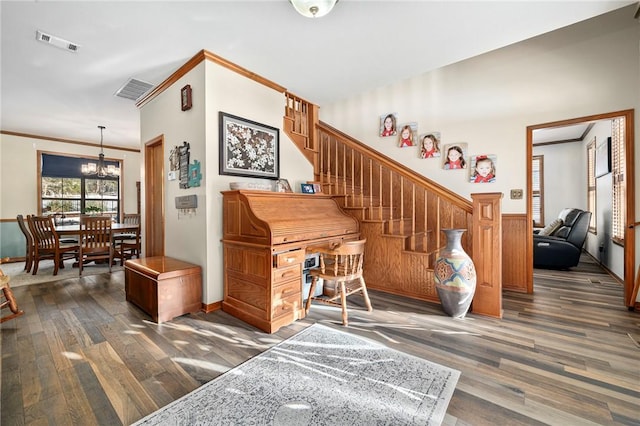 interior space featuring dark wood-type flooring and a chandelier