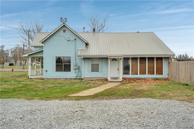 view of front of property featuring a front lawn and a sunroom