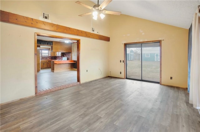 unfurnished room featuring ceiling fan, light wood-type flooring, and high vaulted ceiling