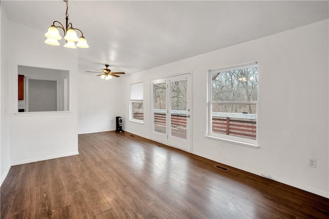 unfurnished living room featuring ceiling fan with notable chandelier and hardwood / wood-style flooring