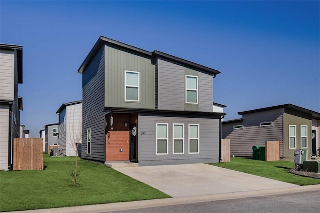 view of front of property with central AC unit and a front yard