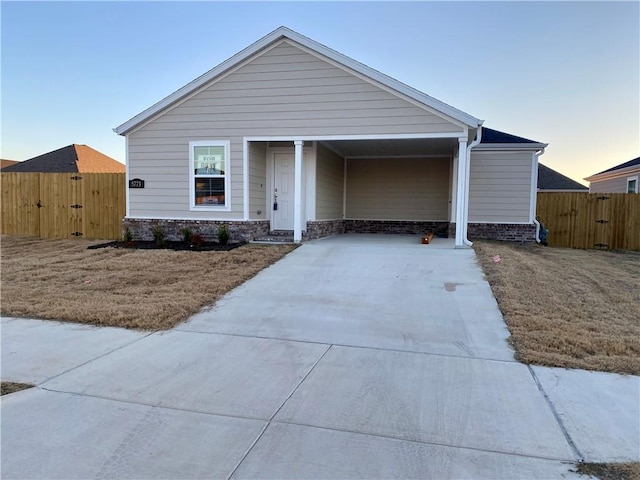 view of front of property with a lawn and a carport