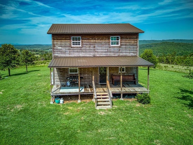 exterior space featuring a wooden deck and a front yard