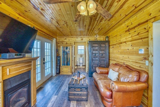 sitting room with wood ceiling, dark hardwood / wood-style floors, a wealth of natural light, and french doors