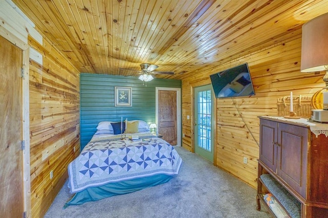 carpeted bedroom featuring ceiling fan, wooden walls, and wooden ceiling