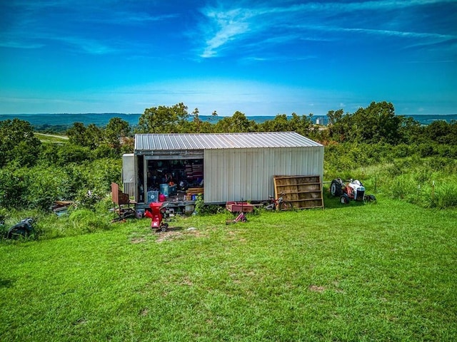 view of outbuilding featuring a yard