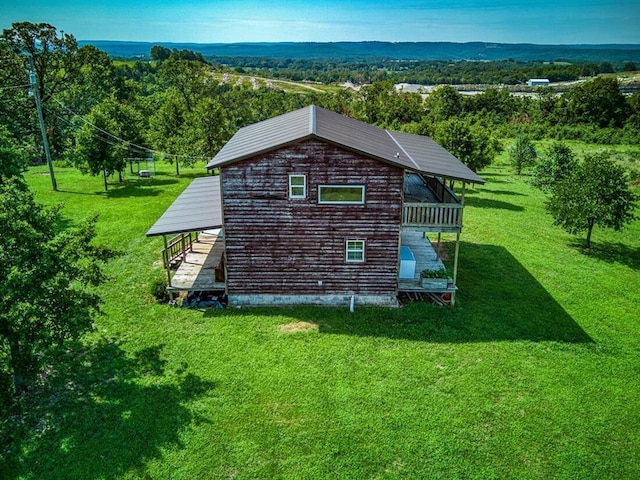 view of side of home with a yard and an outdoor structure