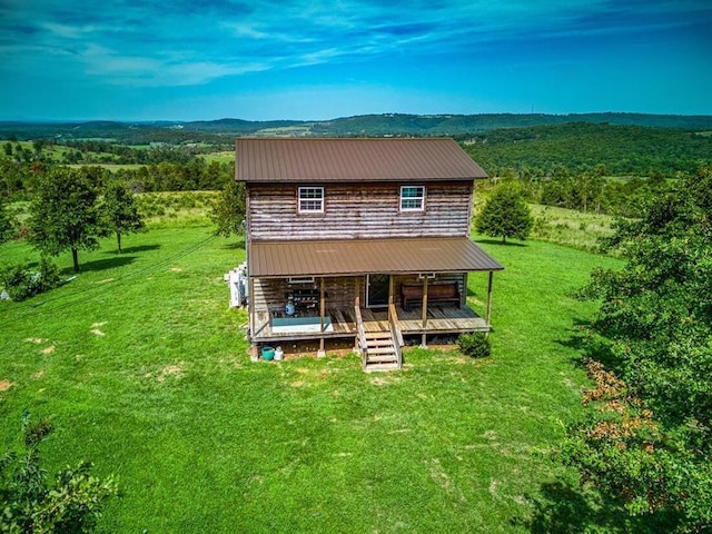 back of house with a lawn and a porch