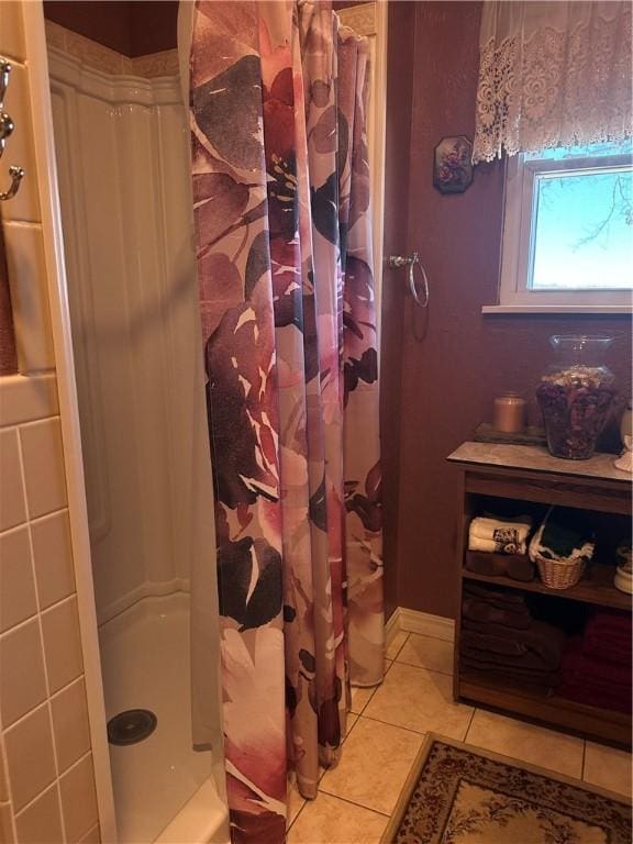 full bathroom featuring curtained shower and tile patterned flooring