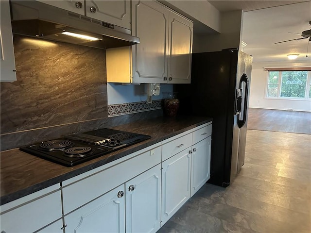 kitchen featuring black appliances, tasteful backsplash, dark countertops, and under cabinet range hood