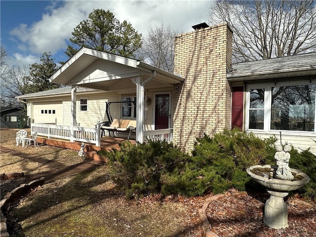 view of front of house featuring a garage and a chimney