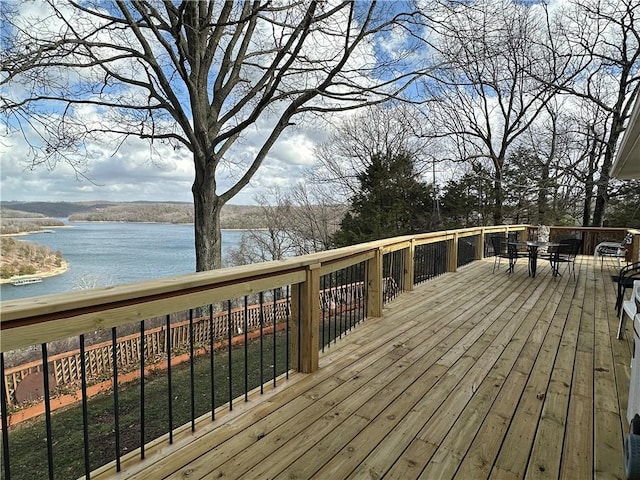 deck featuring a water view and outdoor dining space