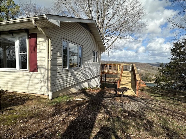 view of property exterior featuring a wooden deck