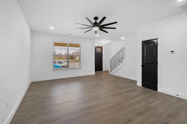 unfurnished living room with ceiling fan and dark wood-type flooring