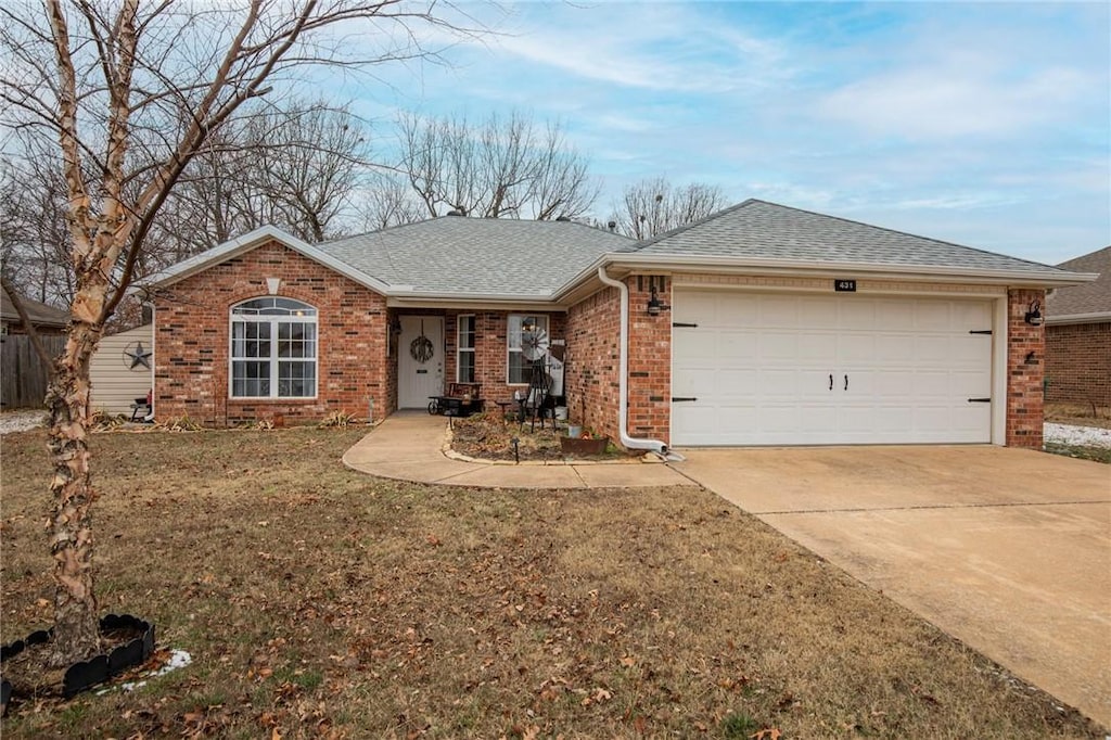 ranch-style home with a front lawn and a garage