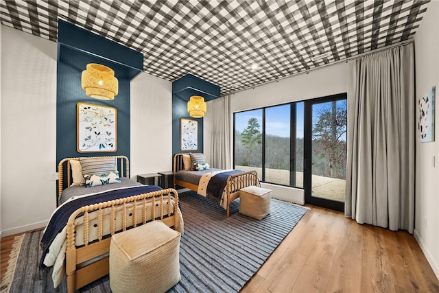 bedroom with light wood-type flooring and access to outside