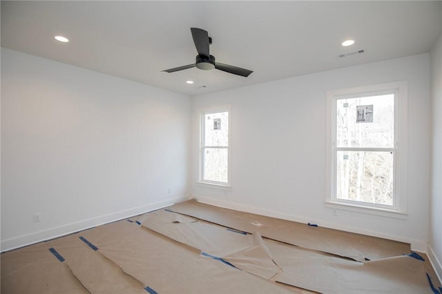 empty room featuring a ceiling fan, recessed lighting, visible vents, and baseboards