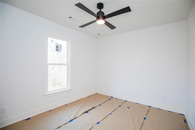 unfurnished room featuring baseboards, visible vents, and a ceiling fan