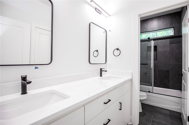20 Singleton Dr, Bella Vista, AR 72715 - bathroom featuring toilet, double vanity, and bath / shower combo with glass door