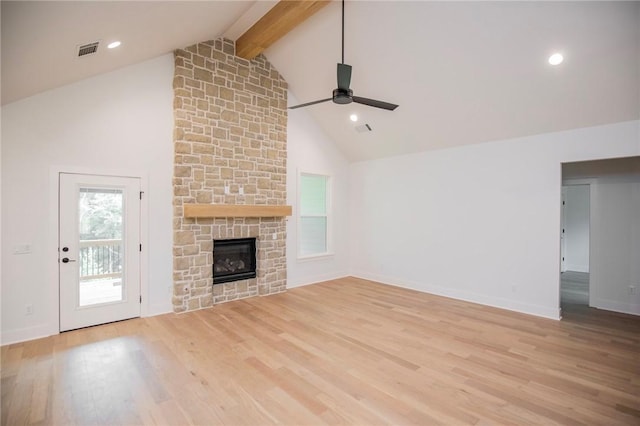 20 Singleton Dr, Bella Vista, AR 72715 - unfurnished living room with a ceiling fan, beam ceiling, wood finished floors, a stone fireplace, and high vaulted ceiling