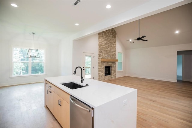 20 Singleton Dr, Bella Vista, AR 72715 - kitchen featuring a sink, stainless steel dishwasher, light wood-type flooring, a ceiling fan, and baseboards