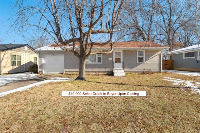 back of property featuring a garage and a lawn