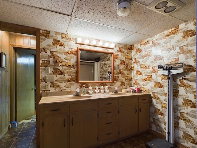 bathroom with a drop ceiling and vanity