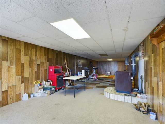 basement featuring carpet and wooden walls