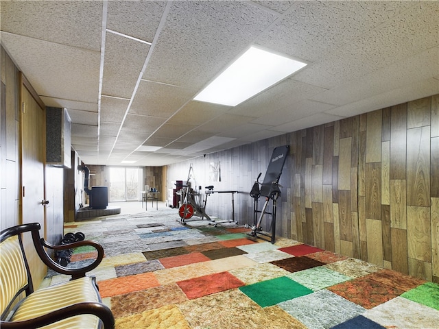 workout area with carpet and wood walls