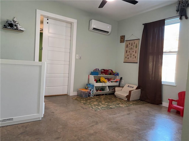 playroom featuring ceiling fan, an AC wall unit, and concrete flooring