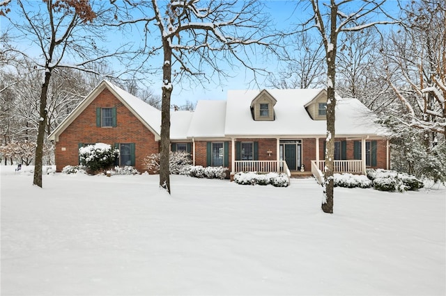 new england style home featuring covered porch