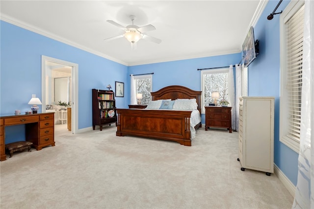 bedroom featuring ceiling fan, light colored carpet, crown molding, and connected bathroom