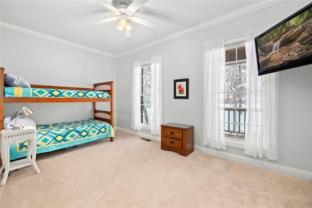 bedroom featuring ceiling fan, ornamental molding, and light carpet