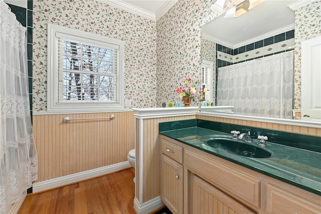 bathroom featuring a shower with curtain, crown molding, hardwood / wood-style floors, toilet, and vanity