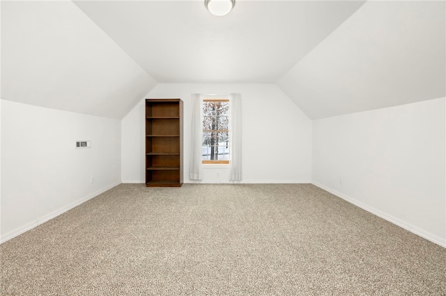 additional living space with carpet floors and lofted ceiling