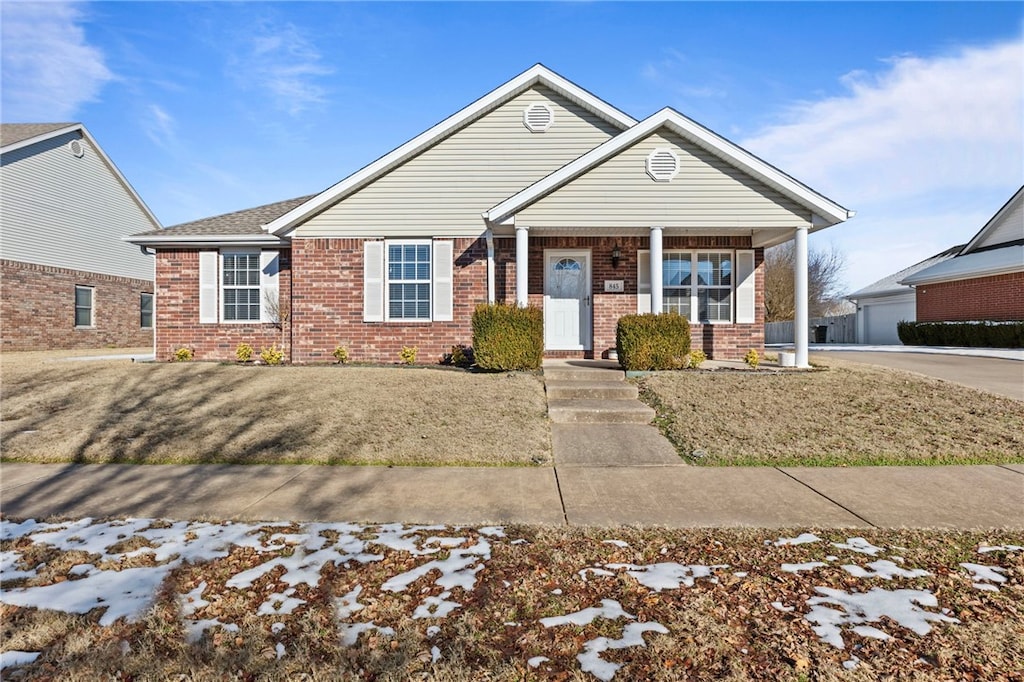 view of front of property with a front yard and covered porch