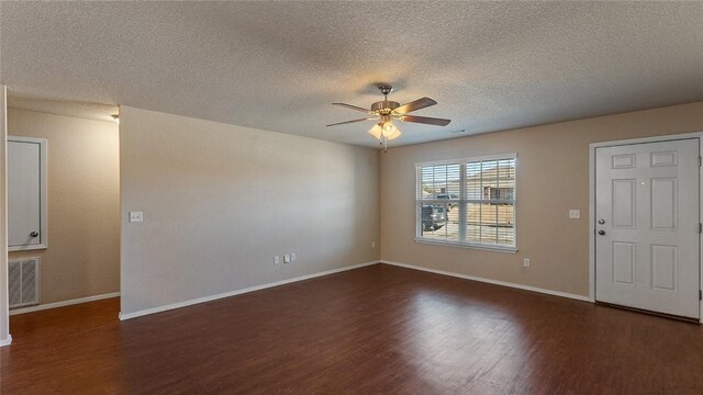 interior space with a textured ceiling, ceiling fan, and dark hardwood / wood-style floors