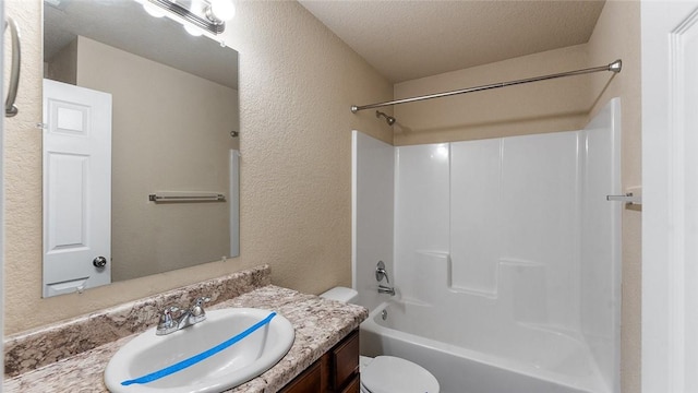 full bathroom with a textured ceiling, toilet, vanity, and  shower combination