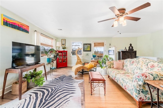 living room featuring light wood-type flooring and ceiling fan