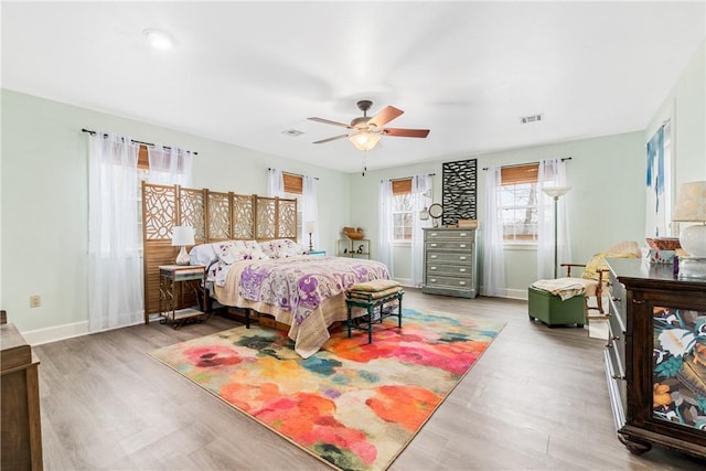 bedroom with ceiling fan and light wood-type flooring