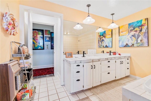 kitchen featuring heating unit, sink, light tile patterned floors, white cabinetry, and hanging light fixtures