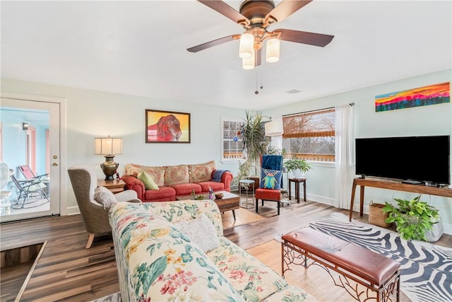 living room with ceiling fan and hardwood / wood-style flooring