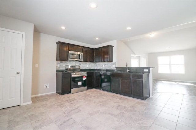 kitchen with kitchen peninsula, stainless steel appliances, backsplash, dark brown cabinets, and sink