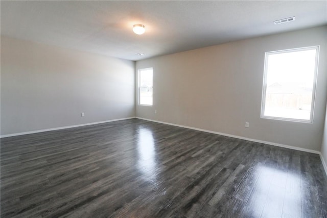 unfurnished room featuring dark wood-type flooring